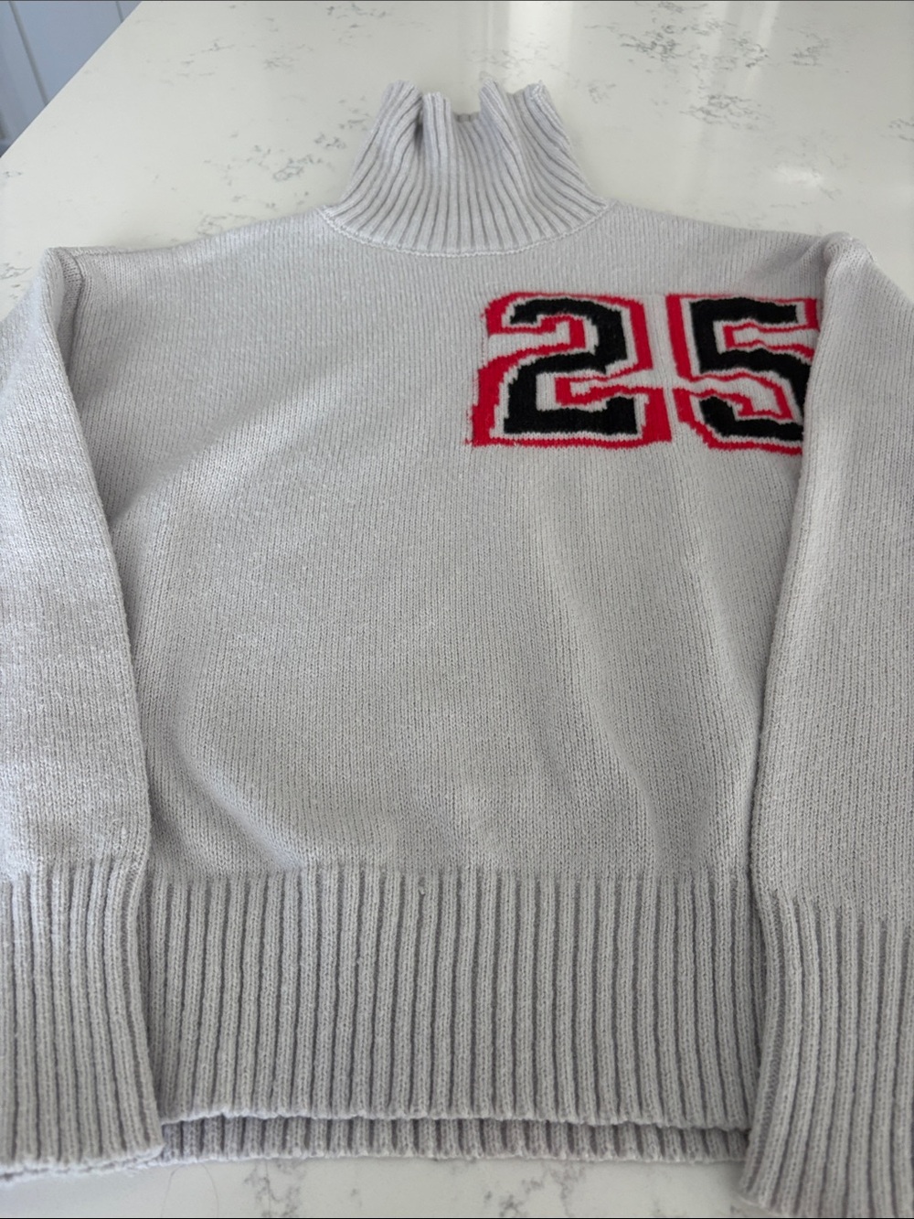 Light Gray Turtleneck Sweater with Red & Black '25' Accent